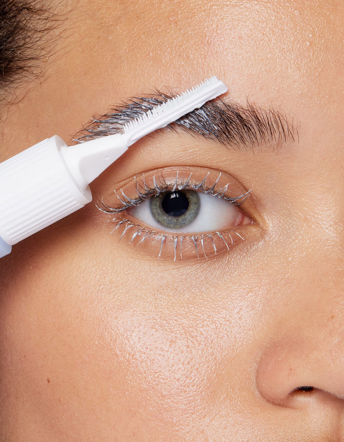 model removing lash and brow masque with tool